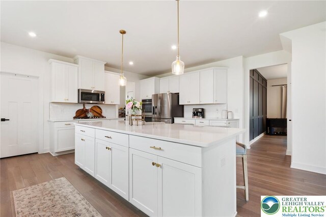 1615 Watson Loop, Upper Macungie Twp, PA 18051 - kitchen with stainless steel appliances, white cabinets, wood finished floors, and recessed lighting