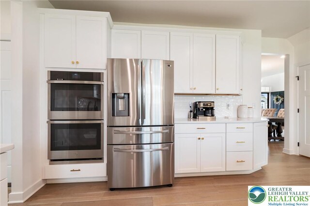 1615 Watson Loop, Upper Macungie Twp, PA 18051 - kitchen featuring appliances with stainless steel finishes, light wood-type flooring, light countertops, and white cabinets