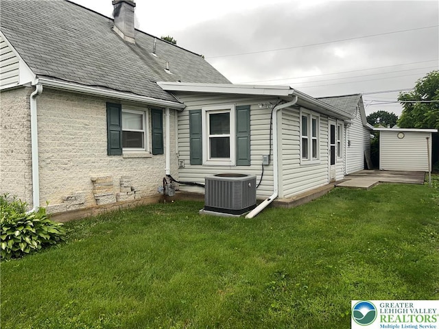 2115 Fireside Dr, Bethlehem City, PA 18018 - rear view of property with a lawn, a chimney, and a shingled roof