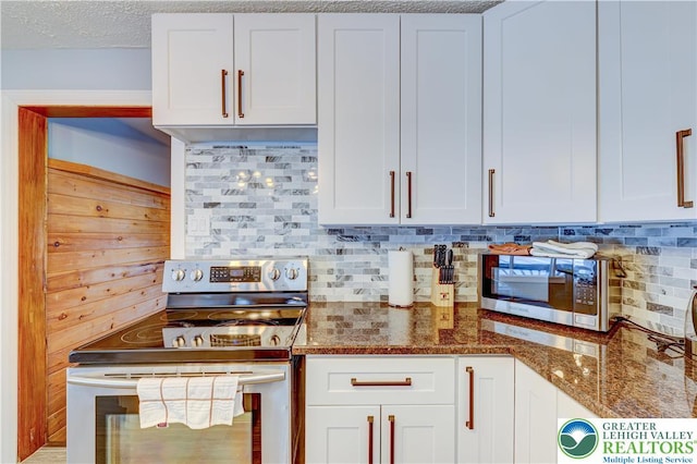 143 Cathleen Dr, Price Twp, PA 18302 - kitchen featuring appliances with stainless steel finishes, backsplash, dark stone countertops, and white cabinets