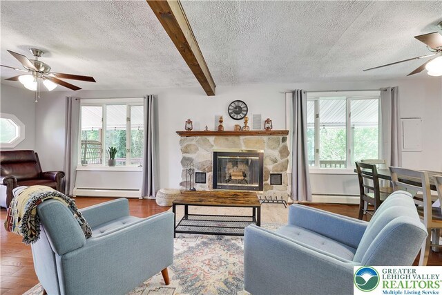 143 Cathleen Dr, Price Twp, PA 18302 - living area featuring a ceiling fan, baseboard heating, a textured ceiling, beam ceiling, and wood finished floors