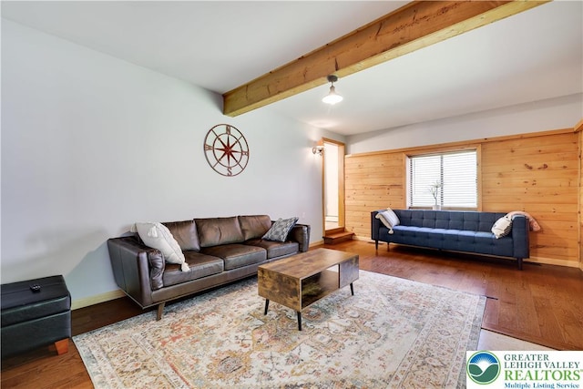 143 Cathleen Dr, Price Twp, PA 18302 - living room featuring beam ceiling, wood finished floors, and wood walls