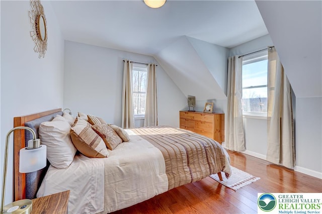 143 Cathleen Dr, Price Twp, PA 18302 - bedroom with multiple windows, wood finished floors, and lofted ceiling