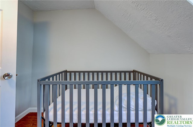 143 Cathleen Dr, Price Twp, PA 18302 - bedroom featuring lofted ceiling, wood finished floors, and a textured ceiling