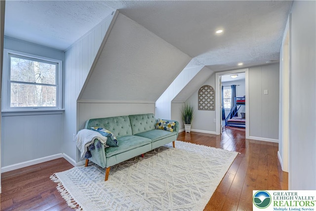 143 Cathleen Dr, Price Twp, PA 18302 - living room featuring wood-type flooring, a textured ceiling, and vaulted ceiling