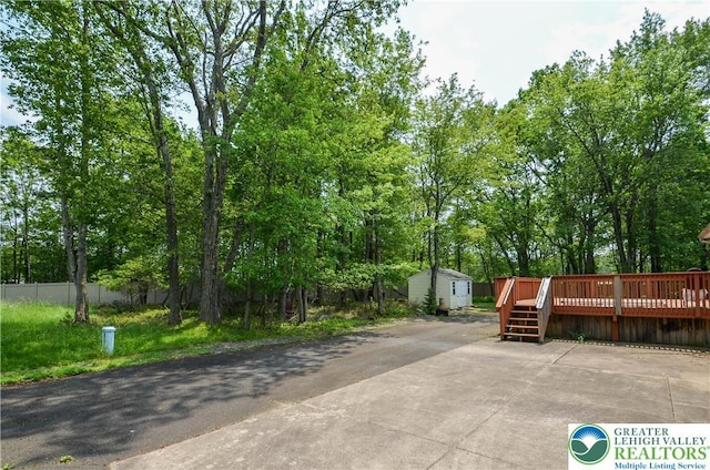 1214 Shadblow Rd, Tobyhanna Twp, PA 18346 - view of patio featuring a shed, a deck, and view of wooded area