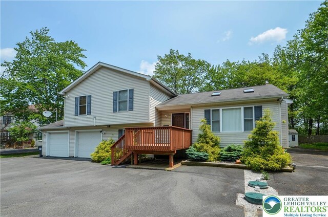 1214 Shadblow Rd, Tobyhanna Twp, PA 18346 - tri-level home with a wooden deck, a garage, and driveway