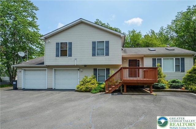 1214 Shadblow Rd, Tobyhanna Twp, PA 18346 - split level home with a wooden deck, asphalt driveway, and an attached garage