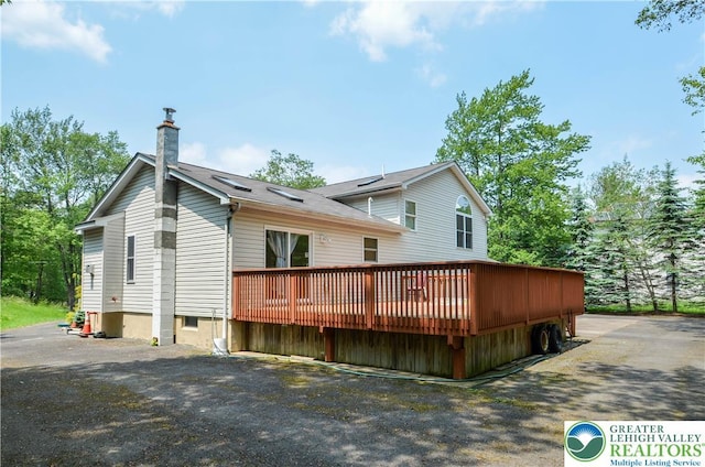 1214 Shadblow Rd, Tobyhanna Twp, PA 18346 - back of house with a chimney and a wooden deck