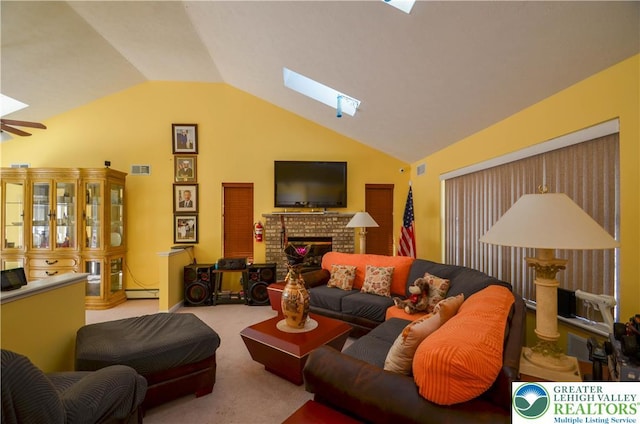 1214 Shadblow Rd, Tobyhanna Twp, PA 18346 - carpeted living room featuring vaulted ceiling, a skylight, a fireplace, a baseboard heating unit, and a ceiling fan