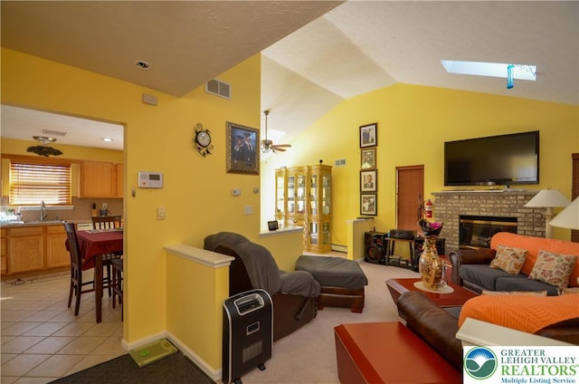 1214 Shadblow Rd, Tobyhanna Twp, PA 18346 - living room with lofted ceiling, a fireplace, ceiling fan, light tile patterned floors, and a baseboard radiator