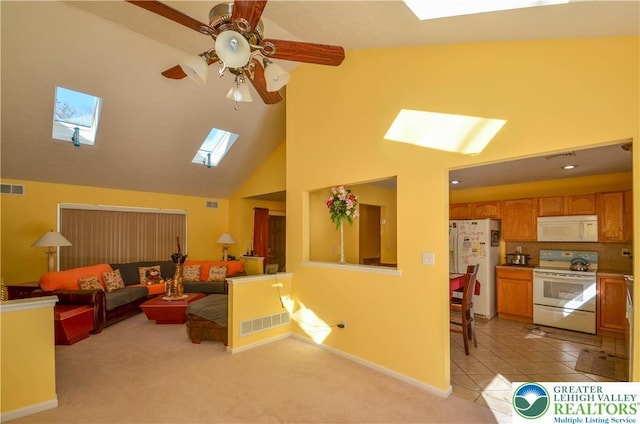 1214 Shadblow Rd, Tobyhanna Twp, PA 18346 - living room featuring a skylight, a ceiling fan, high vaulted ceiling, and light carpet