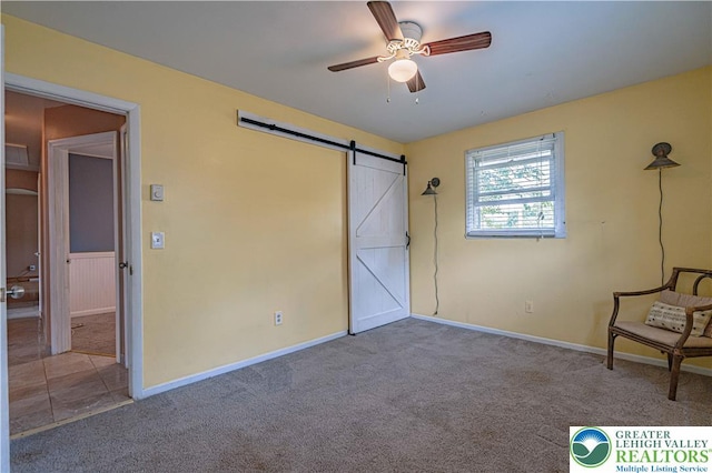 1421 7th St, Bethlehem Twp, PA 18020 - unfurnished bedroom featuring a barn door, carpet floors, and a ceiling fan