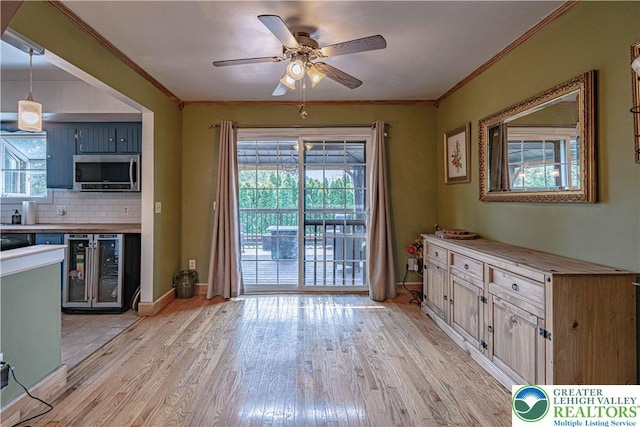 1421 7th St, Bethlehem Twp, PA 18020 - kitchen with stainless steel microwave, beverage cooler, light wood-style floors, ceiling fan, and backsplash