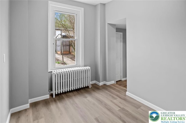 1478 E 5th St, Bethlehem City, PA 18015 - empty room featuring radiator heating unit and wood finished floors