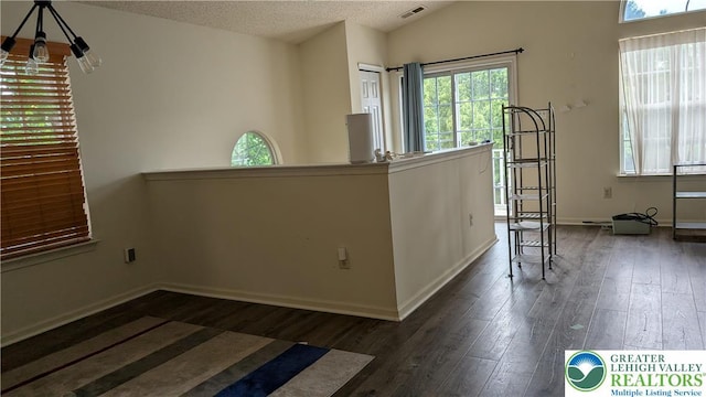 1926 Delancey St, Hellertown Borough, PA 18055 - empty room with wood finished floors, vaulted ceiling, a textured ceiling, and a chandelier