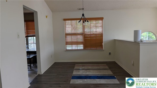1926 Delancey St, Hellertown Borough, PA 18055 - unfurnished dining area featuring healthy amount of natural light, wood finished floors, and a textured ceiling