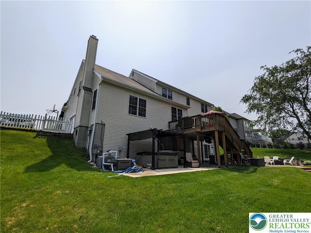 131 Winding Way, Washington Twp, PA 18013 - rear view of house with a hot tub, a wooden deck, a patio area, stairs, and a chimney