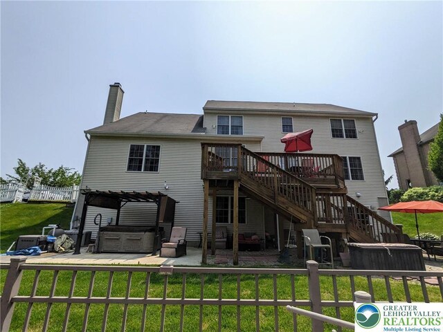 131 Winding Way, Washington Twp, PA 18013 - rear view of property with a wooden deck, stairway, a patio area, a hot tub, and a chimney