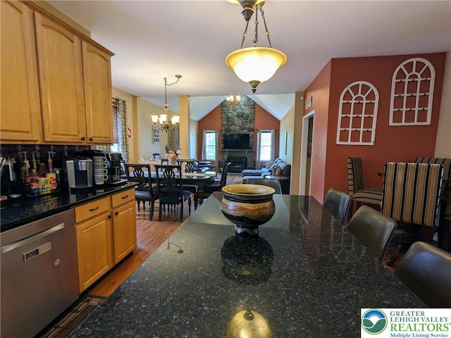 131 Winding Way, Washington Twp, PA 18013 - dining area with wood finished floors, a chandelier, a fireplace, and lofted ceiling