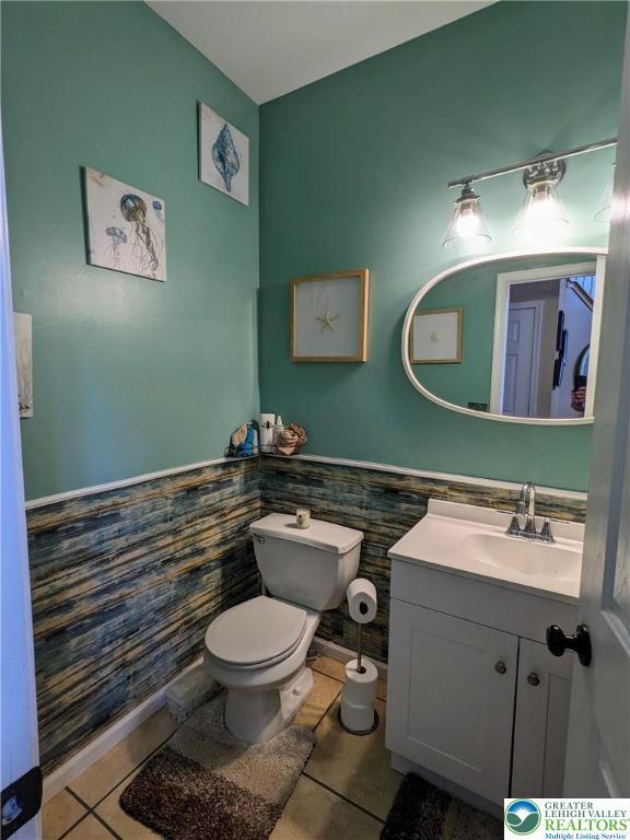 131 Winding Way, Washington Twp, PA 18013 - bathroom featuring tile patterned flooring, vanity, tile walls, and a wainscoted wall
