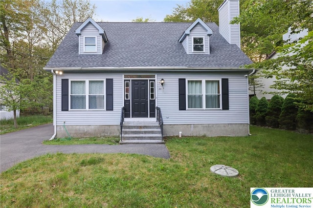 9436 Juniper Dr, Tobyhanna Twp, PA 18466 - cape cod-style house with a front yard, a chimney, and roof with shingles