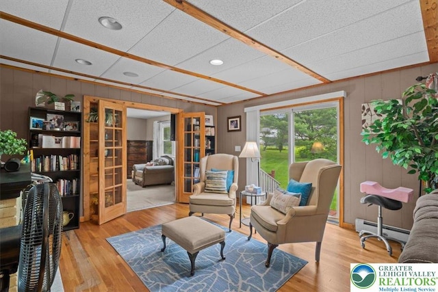 3315 Aspen Rd, Polk Twp, PA 18058 - sitting room with french doors, a baseboard radiator, wood finished floors, wooden walls, and recessed lighting
