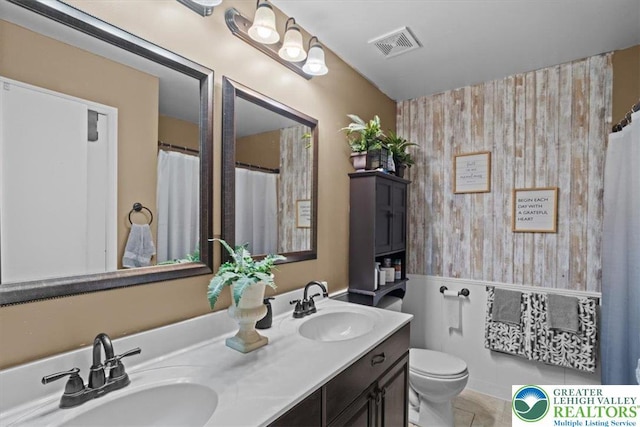 3315 Aspen Rd, Polk Twp, PA 18058 - full bath featuring double vanity, wallpapered walls, an accent wall, and tile patterned floors