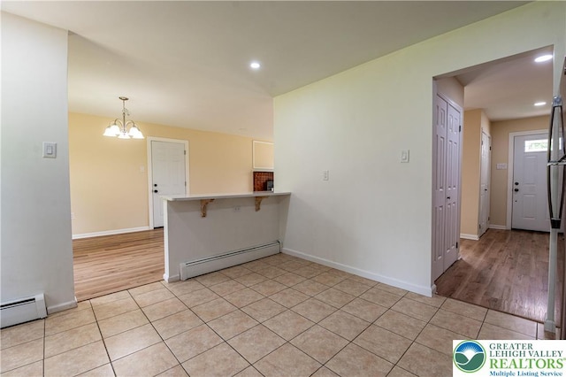 23 Devon Dr, Palmer Twp, PA 18045 - spare room with a baseboard radiator, a chandelier, recessed lighting, and light tile patterned floors