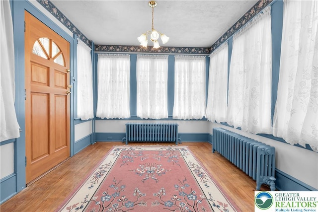 600 S Hoffert St, Fountain Hill Boro, PA 18015 - unfurnished sunroom featuring radiator and a chandelier