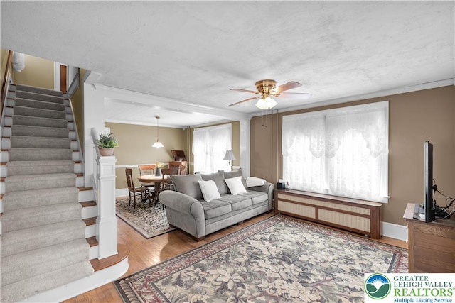 600 S Hoffert St, Fountain Hill Boro, PA 18015 - living area with radiator, a ceiling fan, stairway, wood finished floors, and ornamental molding