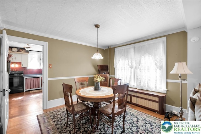 600 S Hoffert St, Fountain Hill Boro, PA 18015 - dining room featuring radiator, wood finished floors, and ornamental molding