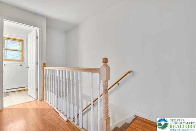 417 Hickory Dr, Jackson Twp, PA 18372 - staircase featuring a baseboard radiator and wood finished floors