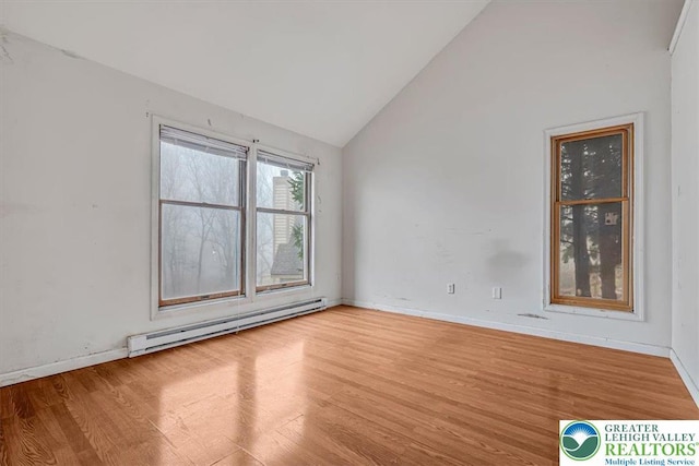 417 Hickory Dr, Jackson Twp, PA 18372 - empty room with a baseboard heating unit, wood finished floors, and lofted ceiling