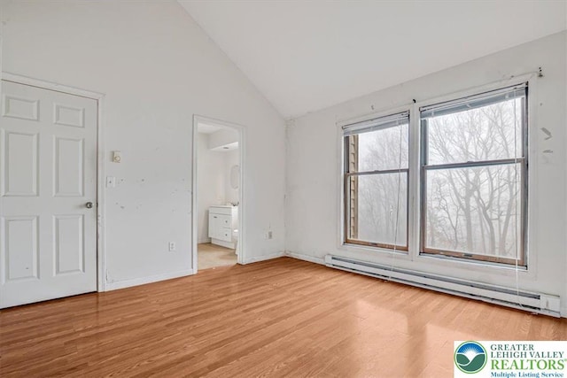 417 Hickory Dr, Jackson Twp, PA 18372 - unfurnished bedroom featuring a baseboard heating unit, wood finished floors, and lofted ceiling