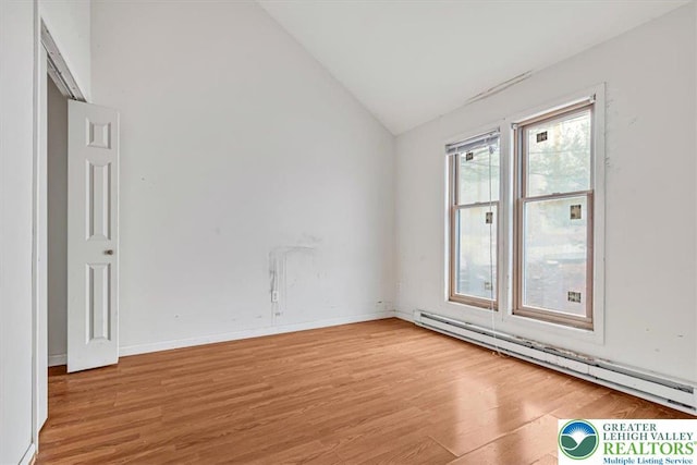417 Hickory Dr, Jackson Twp, PA 18372 - unfurnished room featuring a baseboard heating unit, lofted ceiling, and light wood-type flooring