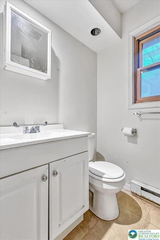 417 Hickory Dr, Jackson Twp, PA 18372 - bathroom with a baseboard heating unit, vanity, and tile patterned flooring