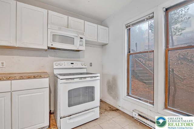 417 Hickory Dr, Jackson Twp, PA 18372 - kitchen with white appliances, white cabinets, light countertops, and light tile patterned flooring