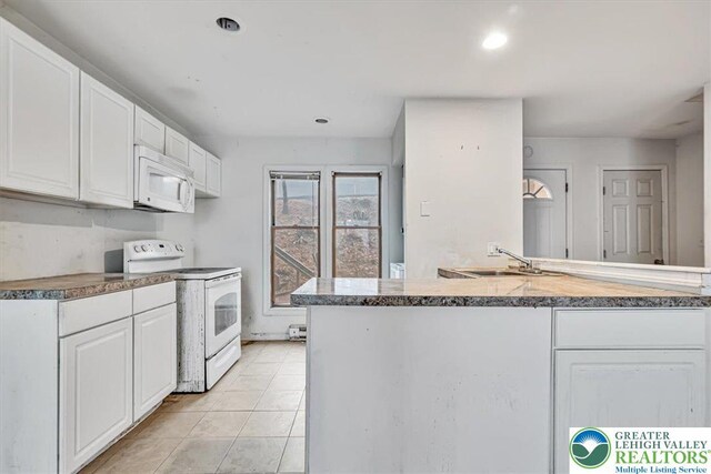 417 Hickory Dr, Jackson Twp, PA 18372 - kitchen featuring white appliances, white cabinetry, light tile patterned floors, recessed lighting, and stone countertops