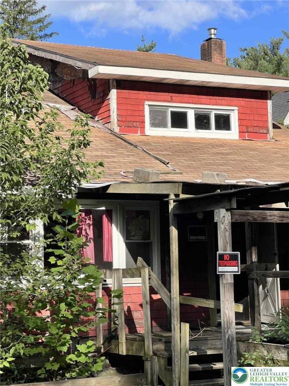 22 Fetherman, Stroudsburg, PA 18360 - view of front facade featuring a shingled roof and a chimney