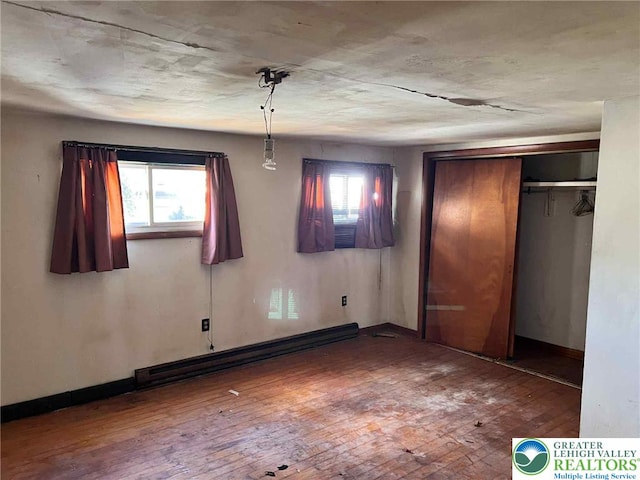 22 Fetherman, Stroudsburg, PA 18360 - unfurnished bedroom with baseboard heating, wood-type flooring, and multiple windows