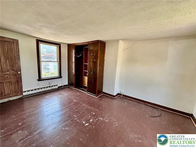342 Race St, Catasauqua Borough, PA 18032 - unfurnished bedroom with a baseboard heating unit, a textured ceiling, and wood finished floors