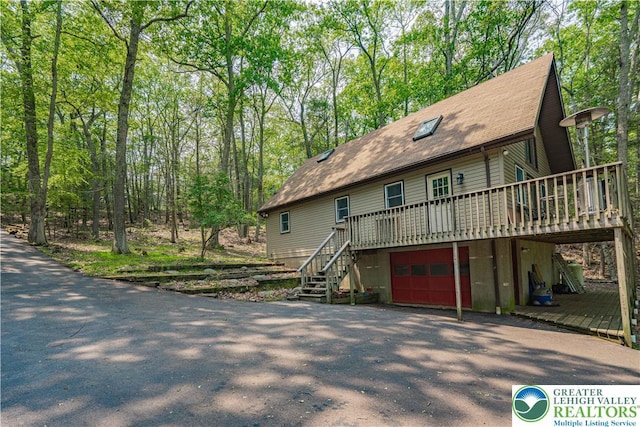 115 Lookout Ct, Middle Smithfield Twp, PA 18302 - raised beach house featuring stairway, a deck, driveway, a garage, and roof with shingles