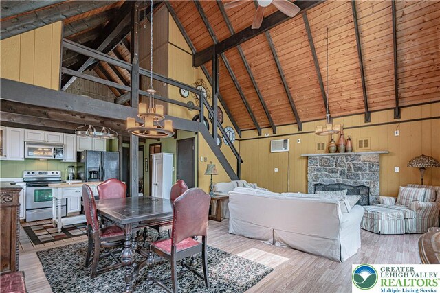 115 Lookout Ct, Middle Smithfield Twp, PA 18302 - dining space featuring a wood ceiling with exposed beams, light wood-style floors, a chandelier, a fireplace, and high vaulted ceiling