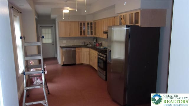 139 N 11th St, Allentown City, PA 18102 - kitchen featuring appliances with stainless steel finishes, light brown cabinetry, glass insert cabinets, ceiling fan, and tasteful backsplash
