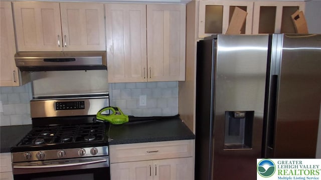 139 N 11th St, Allentown City, PA 18102 - kitchen featuring stainless steel appliances, under cabinet range hood, dark countertops, and tasteful backsplash