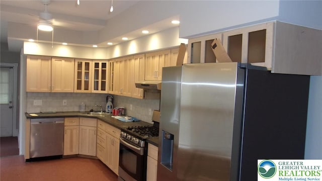 139 N 11th St, Allentown City, PA 18102 - kitchen featuring appliances with stainless steel finishes, dark countertops, under cabinet range hood, decorative backsplash, and ceiling fan