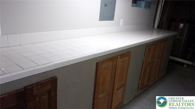 139 N 11th St, Allentown City, PA 18102 - kitchen featuring electric panel, brown cabinetry, and light countertops
