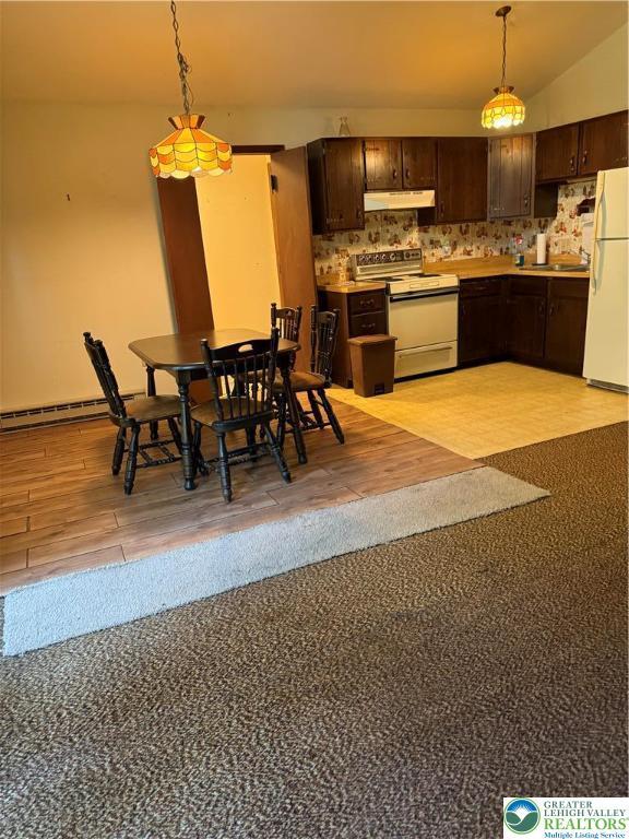 9817 Deerwood Dr, Coolbaugh Twp, PA 18466 - dining area featuring a baseboard radiator and light wood-style flooring