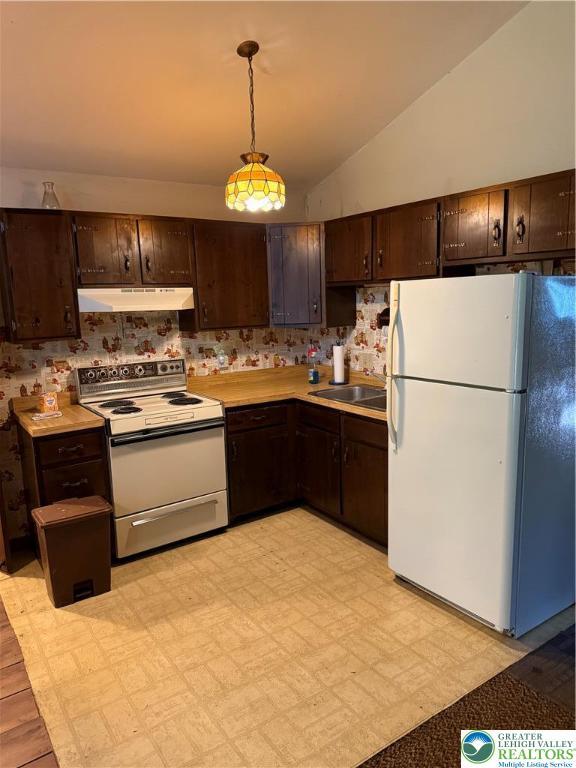9817 Deerwood Dr, Coolbaugh Twp, PA 18466 - kitchen featuring white appliances, under cabinet range hood, dark brown cabinetry, lofted ceiling, and light countertops